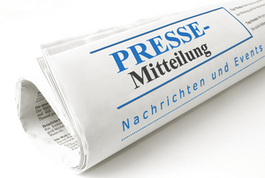 Abbildung einer zusammengerollten Zeitung auf der "Pressemitteilung" steht.